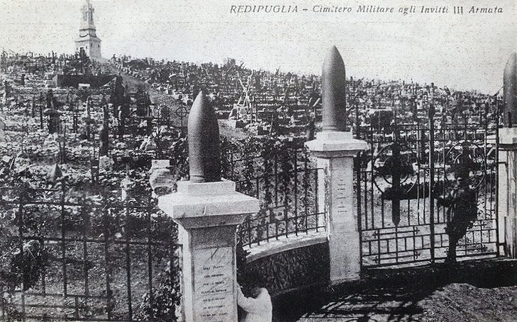 Historic cemetery with ornate gates and a distant tower among graves.