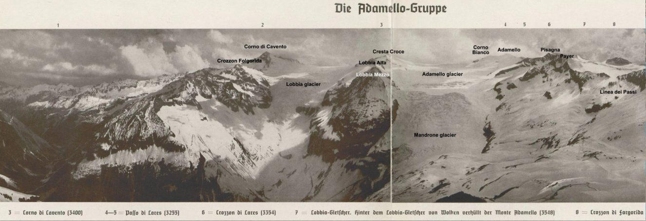Panoramic view of snow-capped mountains with labelled peaks and valleys.
