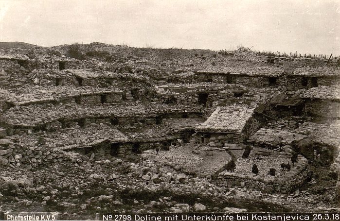 Ruined buildings and debris in a devastated landscape.