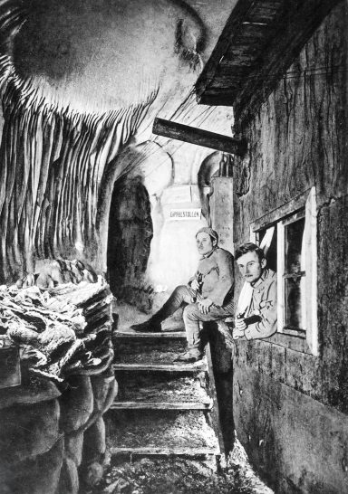 Two men sit near a building with sacks, surrounded by a rustic, detailed environment.